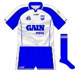 2004:
For the 2004 Munster hurling semi-final with Tipperary, Waterford used this jersey, which had no white stripe on the sleeve but instead a blue one on the white part, and a different collar. The previous design returned for the rest of the year.